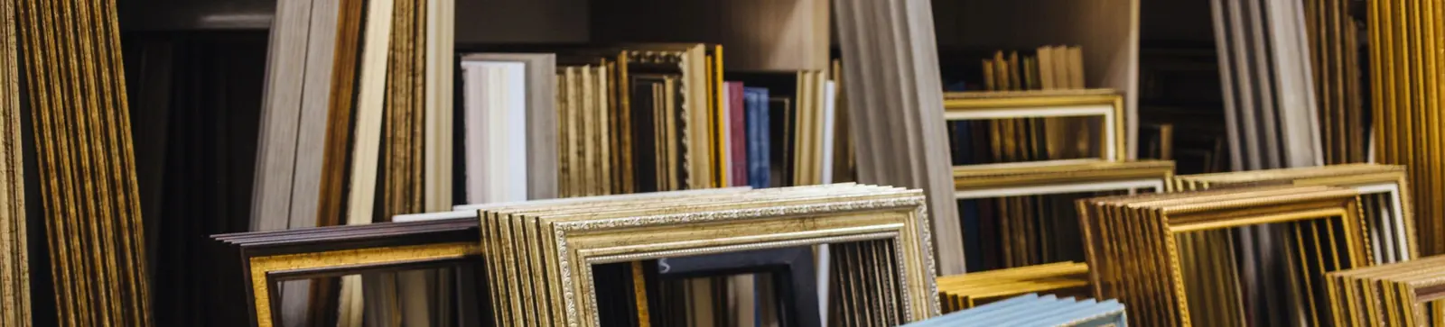 Finished frames stacked against the shop shelving