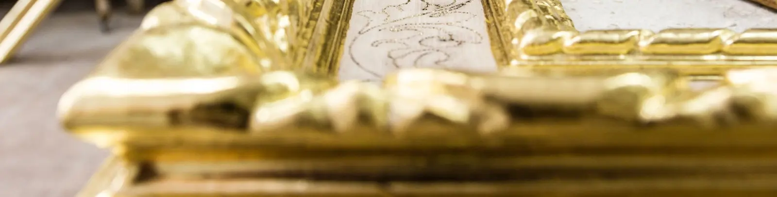 Close-up of a carved gold frame corner